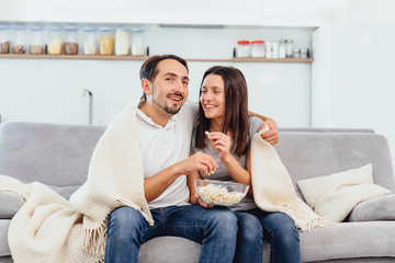A woman and husband wandering the TV