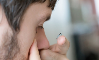 Contact lens and man eye, close up