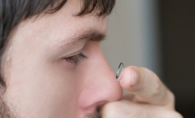 Contact lens and man eye, close up