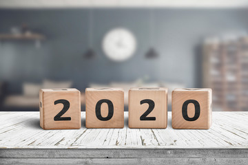 Year 2020 sign on a wooden desk in a cozy kitchen
