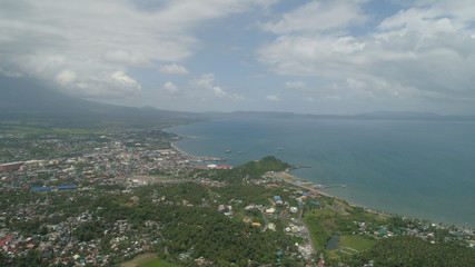 Obraz premium Aerial view city Legazpi in background Mayon volcano. Tropical landscape city near volcano on seashore, Philippines, Luzon.