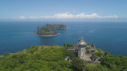 Aerial view of lighthouse in Palau island. Lighthouse in cape Engano against blue sky and rocky...