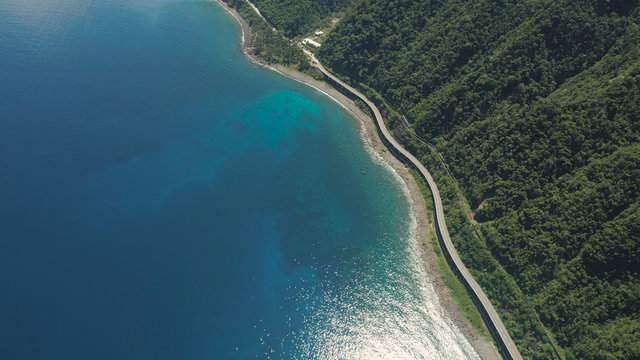 Aerial view of Patapat viaduct in the coast of Pagudpud, Ilocos Norte. Highway with bridge by coast sea near the mountains. Philippines, Luzon. Highway along the coast.