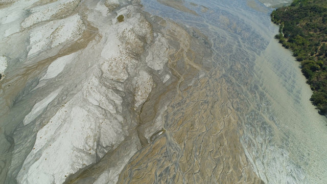 Parched river in mountain province Luzon, Philippines. Aerial view Drought in mountain valley, dry and shallow Bucao river.