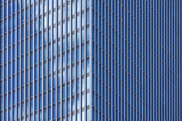Fototapeta na wymiar Angle modern business building skyscraper blue glass and aluminum, white square. Windows of facade. Modern apartment buildings in new neighborhood. Windows of a building, texture.