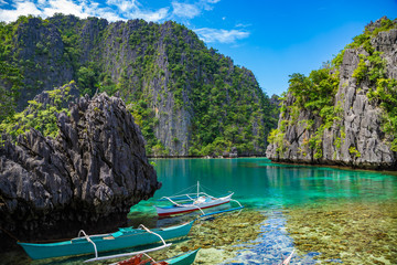 CORON / PHILIPPINES - OCTOBER 31, 2018: Traditional outrigger tourist boats at the landing station for Kayangan Lake. Travel vacation at Philippines.