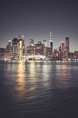 Fototapeta na wymiar New York City skyline at night, color toned picture, USA.