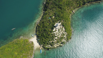 Statue of Jesus Christ on Pilgrimage island in Hundred Islands National Park, Pangasinan, Philippines. Aerial view of group of small islands with beaches and lagoons, famous tourist attraction