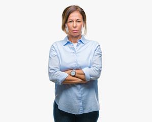 Middle age senior hispanic woman over isolated background skeptic and nervous, disapproving expression on face with crossed arms. Negative person.