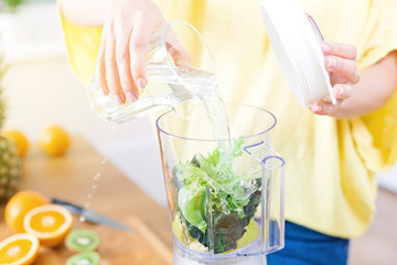 Preparing detox fruits smoothie in blender