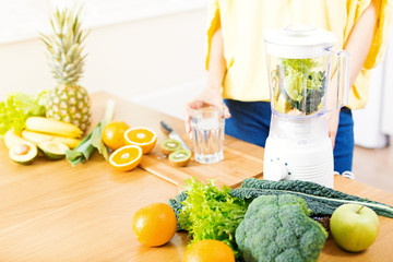 Preparing detox fruits smoothie in blender