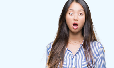 Young asian woman over isolated background afraid and shocked with surprise expression, fear and excited face.