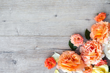 Flowers composition on wooden background. Valentines day background. Flat lay, top view, copy space.