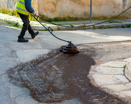 bituminous emulsion sprayed on the surface before starting the laying of the asphalt for road repair