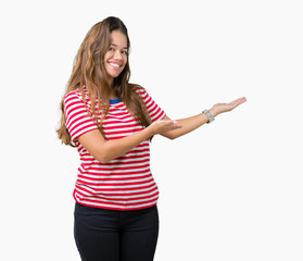 Young beautiful brunette woman wearing stripes t-shirt over isolated background Inviting to enter smiling natural with open hand