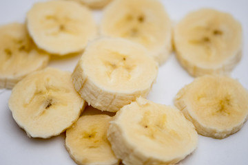 The small slices of bananas on the white background