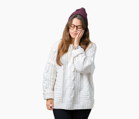 Young beautiful brunette hipster woman wearing glasses and winter hat over isolated background thinking looking tired and bored with depression problems with crossed arms.