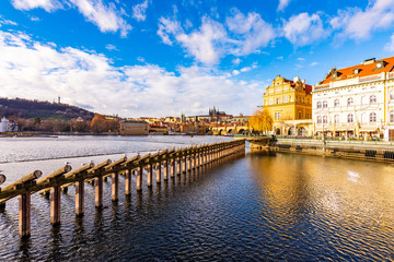 Prague, Czech republic: Look to Charles bridge and Prague castle in far. Sunny winter day near the Vltava river. Panorama view of Prague city, cityscape with Prague castle. Czech capital