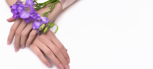 Fashion art portrait woman in summer dress and flowers in her hands with a bright contrasting makeup. Creative beauty photo girls sitting at table on white background