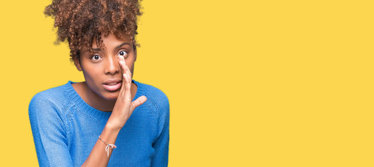 Beautiful young african american woman over isolated background hand on mouth telling secret rumor, whispering malicious talk conversation - obrazy, fototapety, plakaty