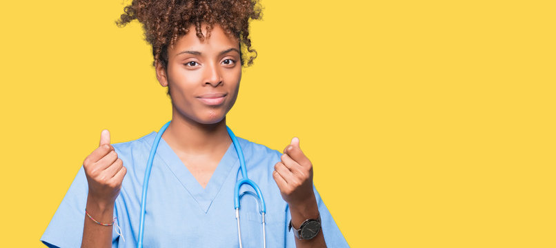 Young african american doctor woman over isolated background Doing money gesture with hand, asking for salary payment, millionaire business