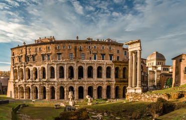 Fototapeta na wymiar The Theatre of Marcellus, an ancient open-air theatre in Rome, Italy, built in the closing years of the Roman Republic. The ruins of Temple of Apollo Palatinus are on the right.