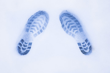 two shoe prints on snow, top view, copy space, cloudy and foggy