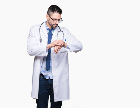 Handsome young doctor man over isolated background Checking the time on wrist watch, relaxed and confident