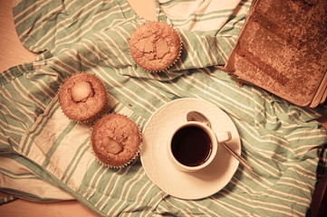 Flat lay of a cup of coffee, an old book and some handmade crafts