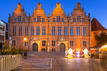 Architecture of the old town in Gdansk with emblem of the city made by lights, Poland