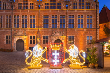 Obraz premium Architecture of the old town in Gdansk with emblem of the city made by lights, Poland