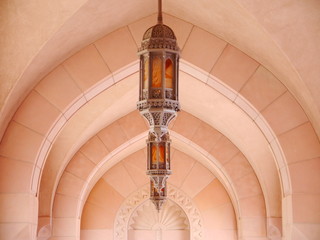 detail of arab architecture with stone arches and ornamented lantern, mosque in Muscat, Oman,...