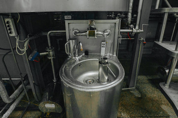 Modern brewery and equipment machinery tools for alcohol production. Steel vats or tanks and stainless pipes.