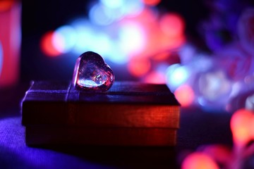 Glowing pink roses. A composition from light for St. Valentine's Day. Roses in a romantic atmosphere and bokeh of heart