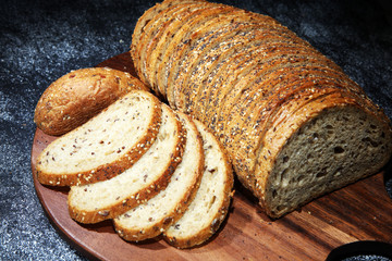 freshly baked bread on wooden board. cutted bread
