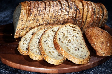 freshly baked bread on wooden board. cutted bread