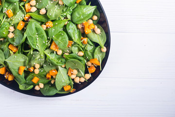 autumn salad with pumpkin , spinach , chickpea and sesame