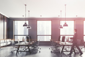 Gray and wooden open space office side view, man