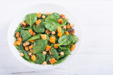 autumn salad with pumpkin , spinach , chickpea and sesame
