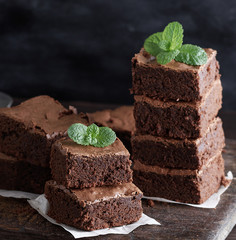 stack of square pieces of baked brown brownie pie