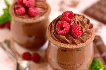 Homemade chocolate mousse with fresh raspberry.