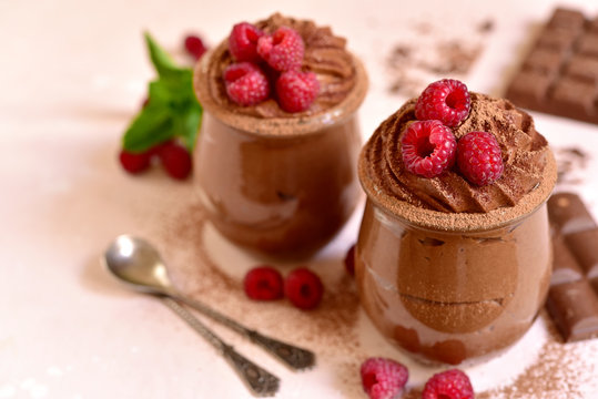 Homemade chocolate mousse with fresh raspberry.