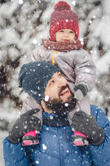Portrait of a happy man piggybacking his cheerful child. happy father and baby son having fun under...