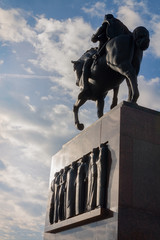 Statue of King Tomislav in Zagreb, Croatia as seen from the back, with blue sky and white clouds