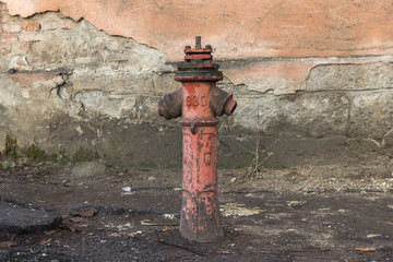 Red hydrant on the street. Fire extinguishing agent. Pipe with water. Fire system in the old days....