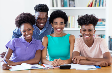 Portrait of female teacher with african american students