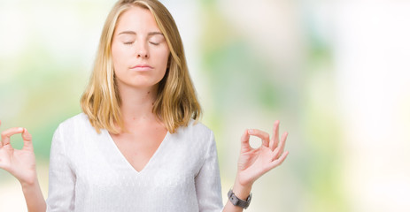 Beautiful young elegant woman over isolated background relax and smiling with eyes closed doing meditation gesture with fingers. Yoga concept.