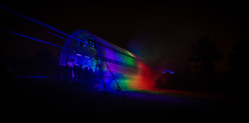 Futuristic abstract rainbow glowing colorful photon tunnel made from DMX lights 