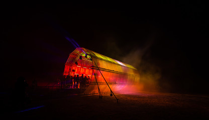 Futuristic abstract glowing colorful photon tunnel light by blue DMX lights