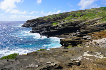View of the Pacific Ocean crashing onto lava rocks at Hanauma Bay on the south-eastern shore of Oahu, Hawaii